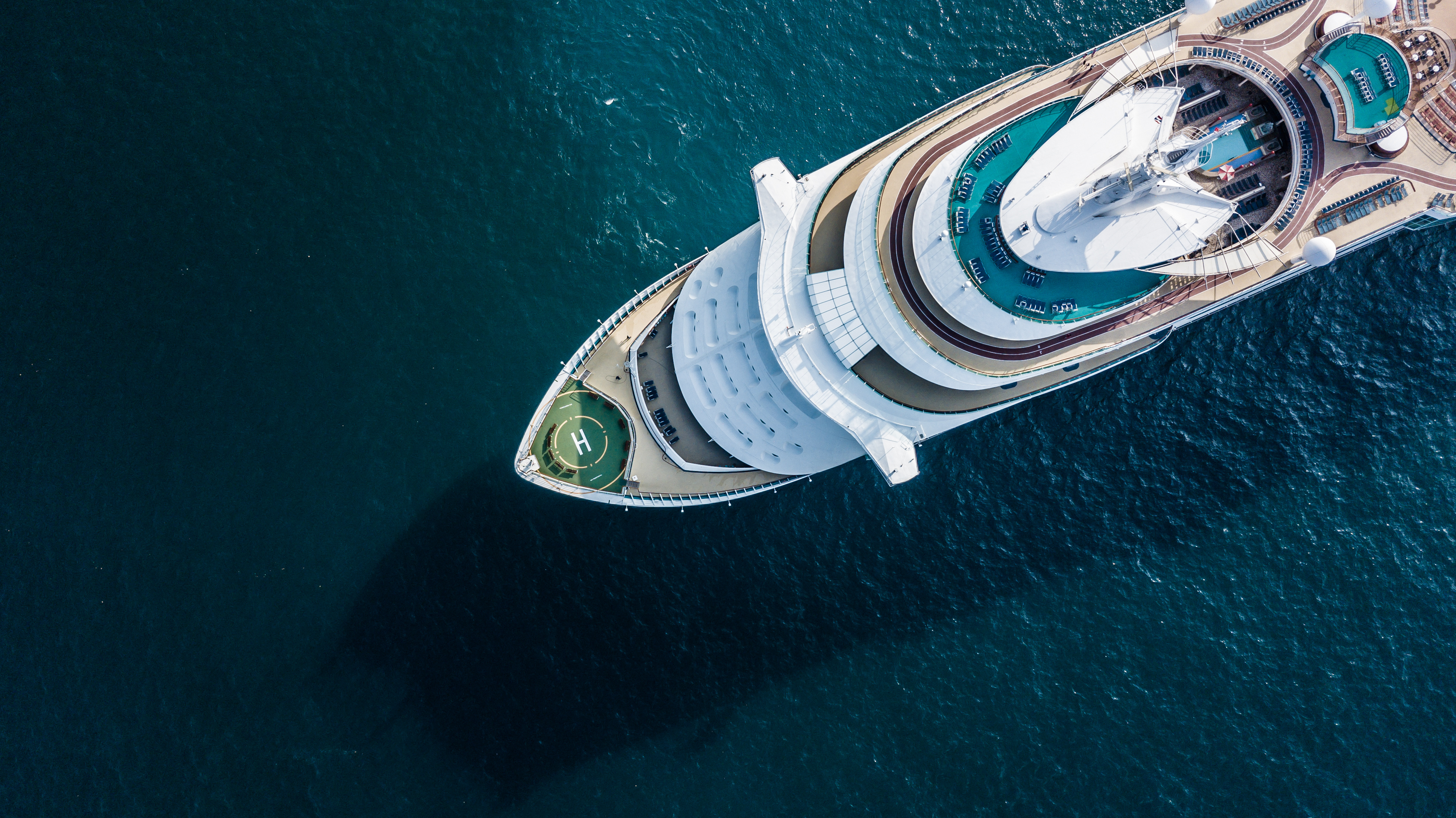 Person sitting on floor working on laptop